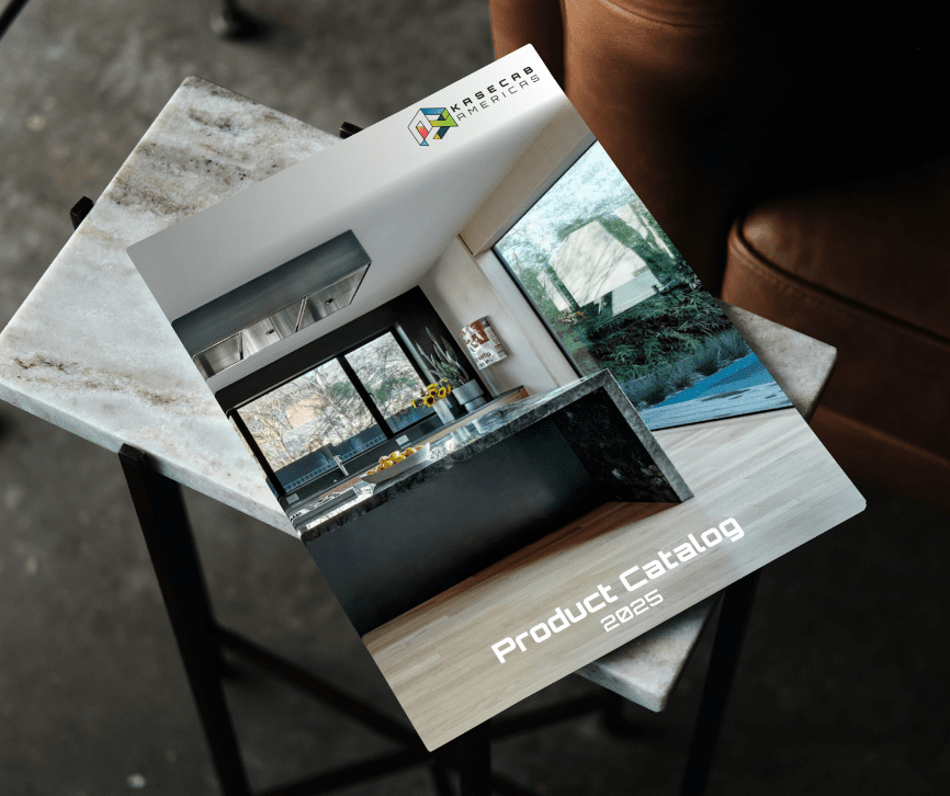 A product catalog titled "Product Catalog 2025" rests on a glossy, marble-look table. The cover features a modern kitchen with large windows and a black countertop.